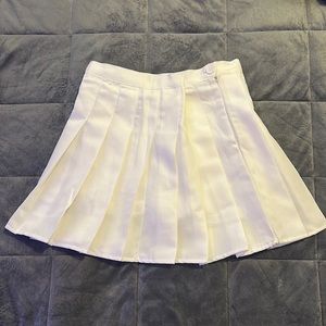 Short white pleated skirt with under shorts